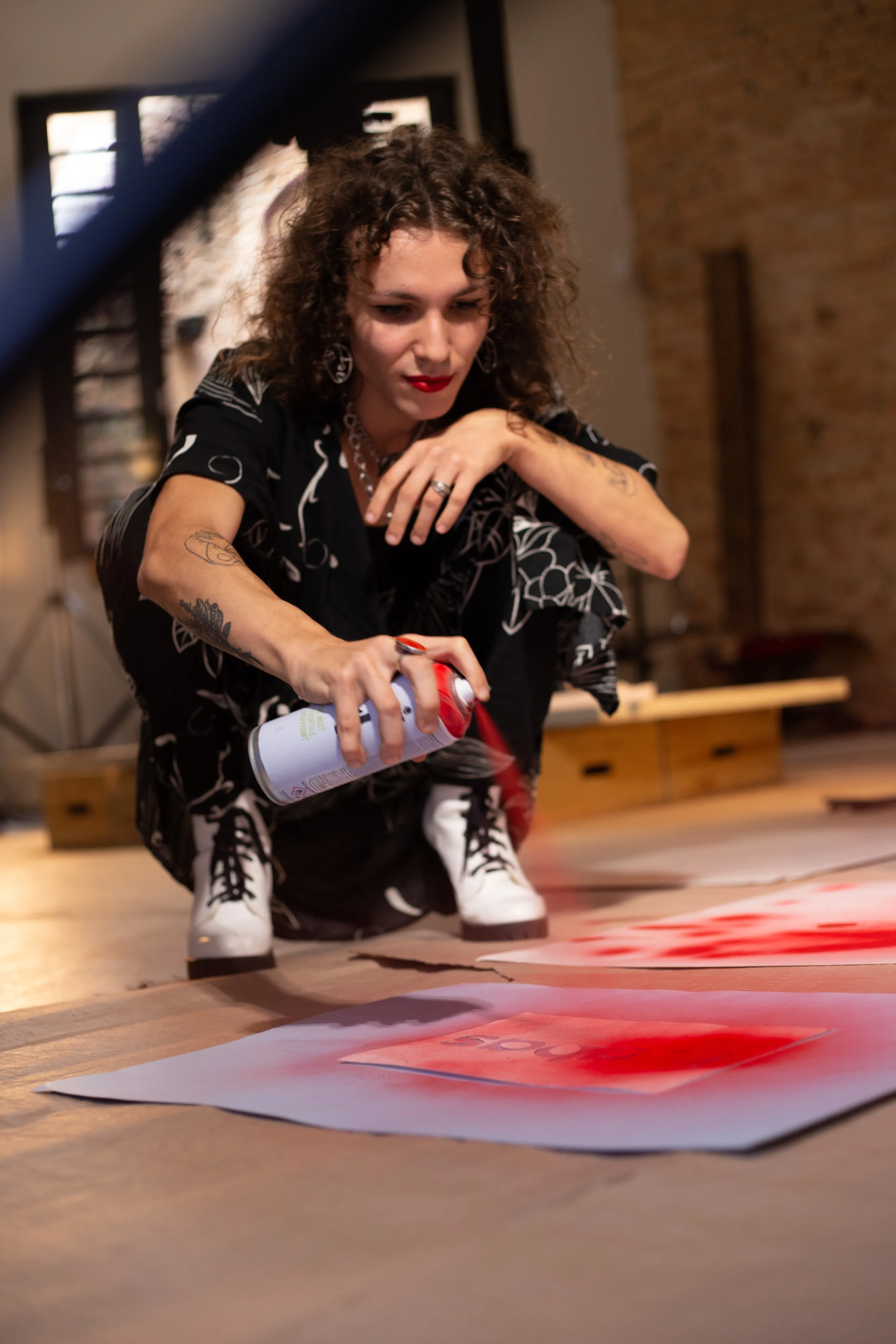 Joanna using spray paint to create the Adidas logo for the campaign